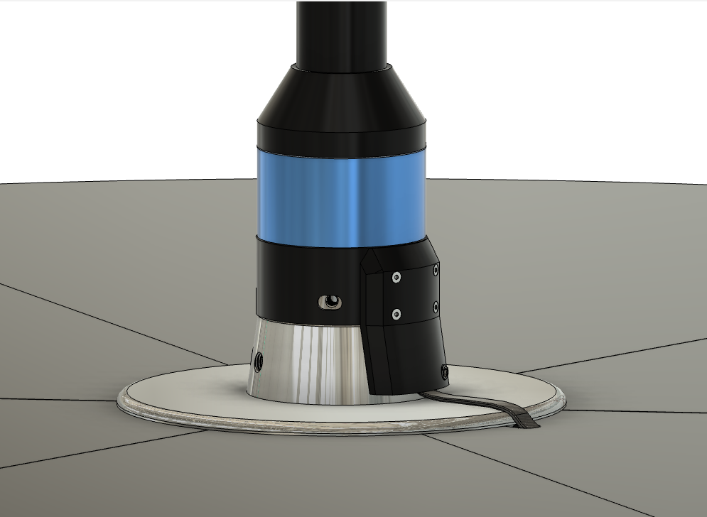 The middle of the stage with the pole installed. From the top: the pole tube, a tapered pole base, a colored band, a black body with a cable block bolted to one side, a chrome carrier cone, and the stage top plate. A flat lead leaves the block and crosses the plate.